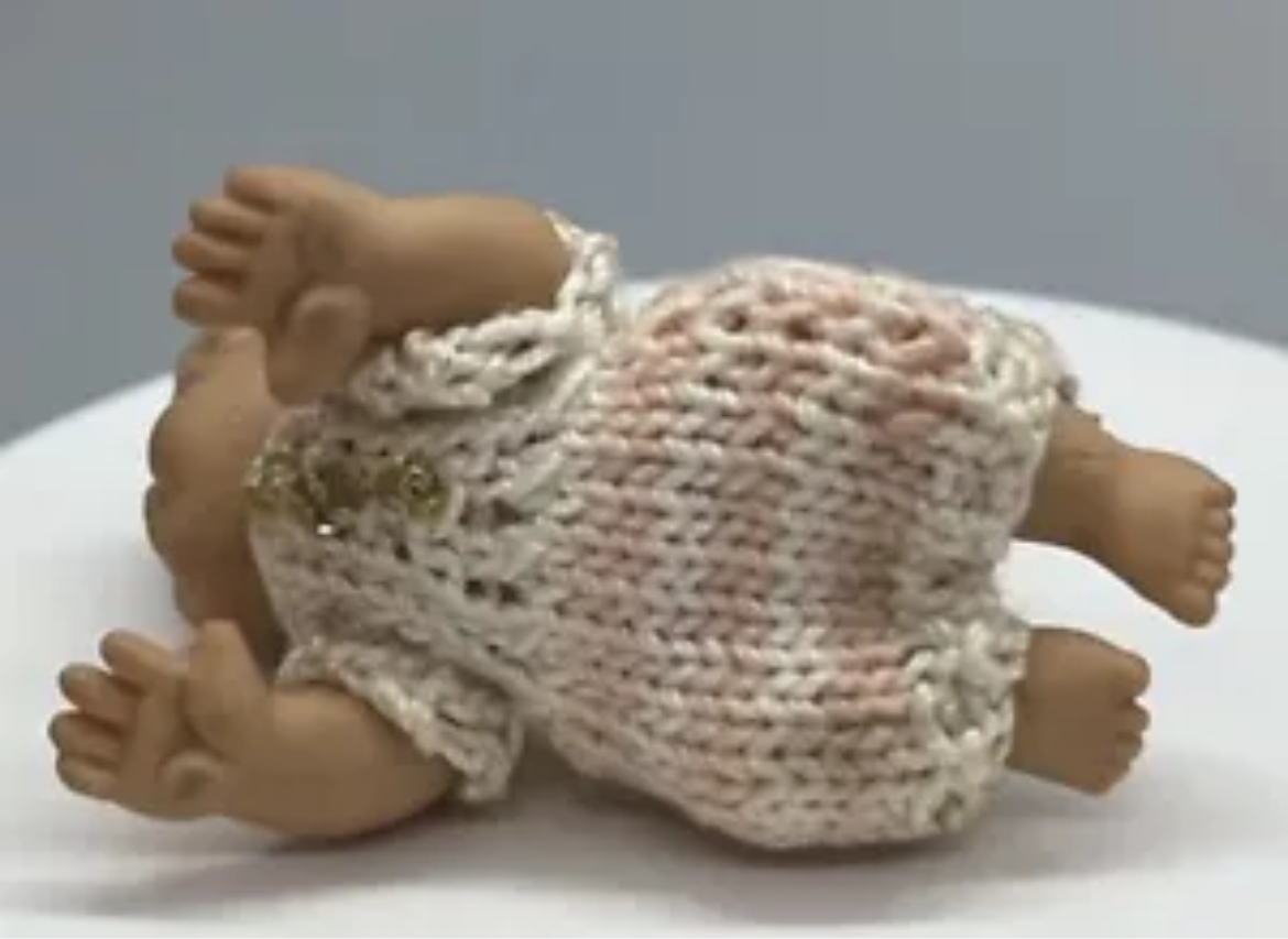 Dolls house baby with hand knitted romper
