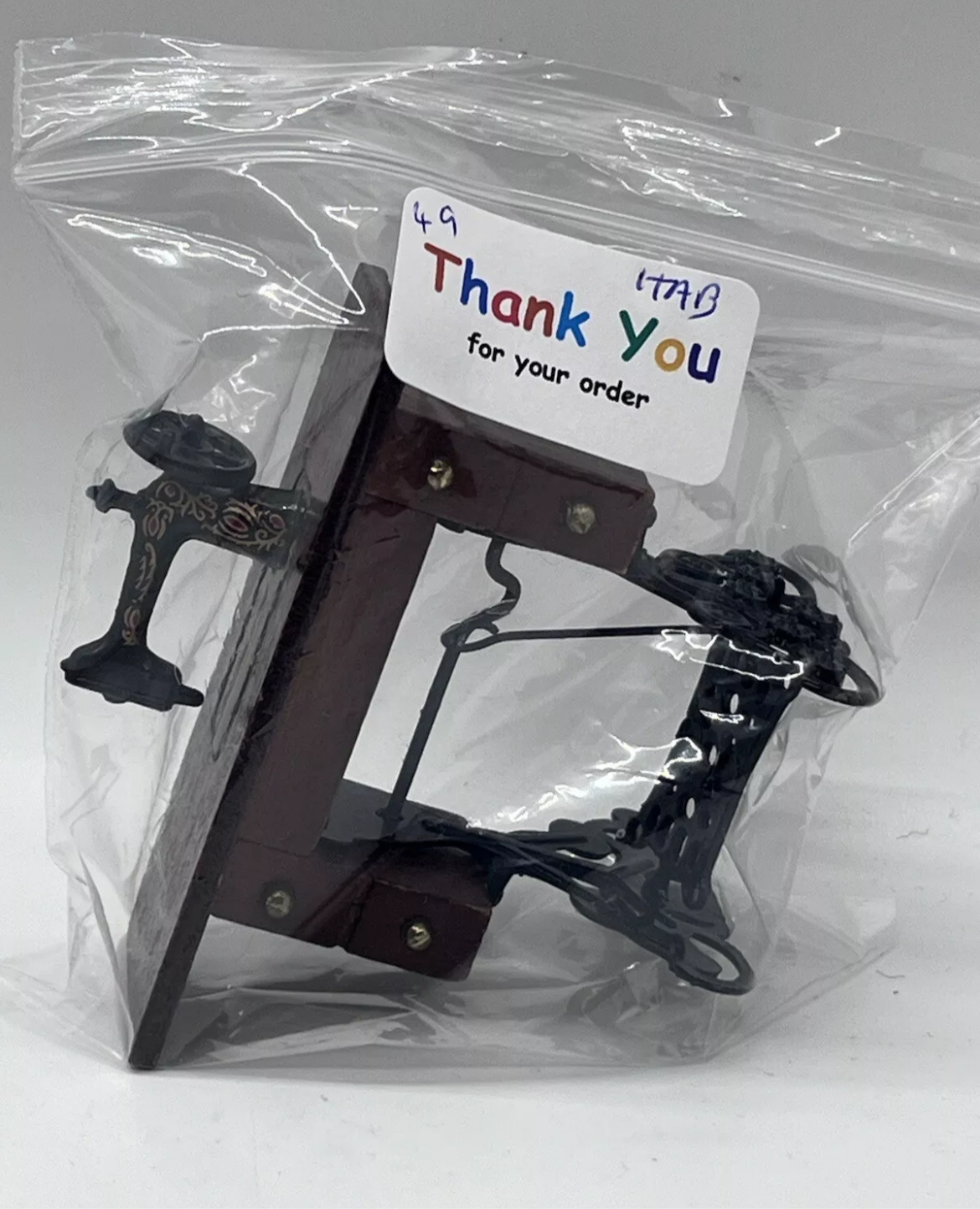 Dolls house sewing machine on table