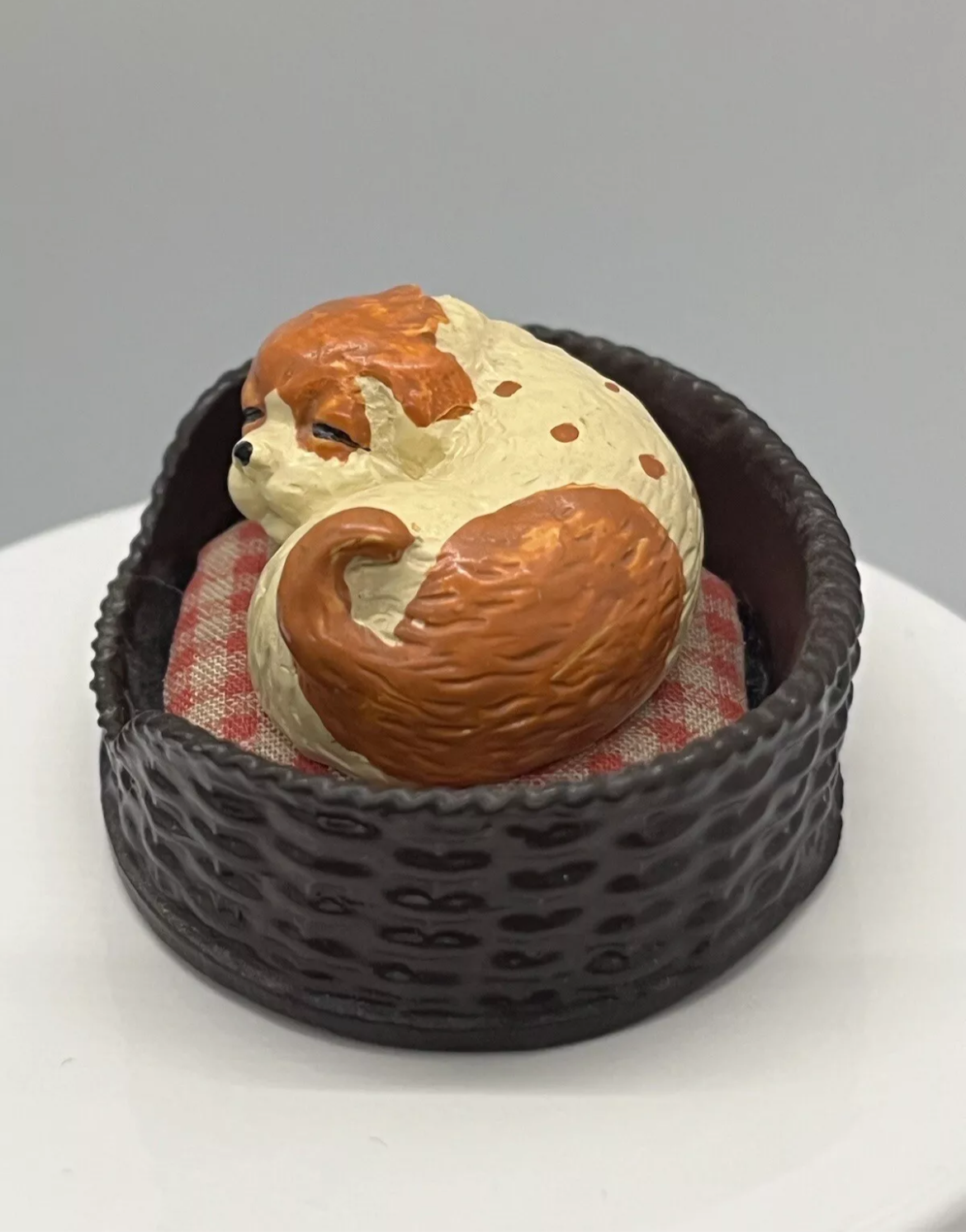 Dolls house sleeping dog in basket