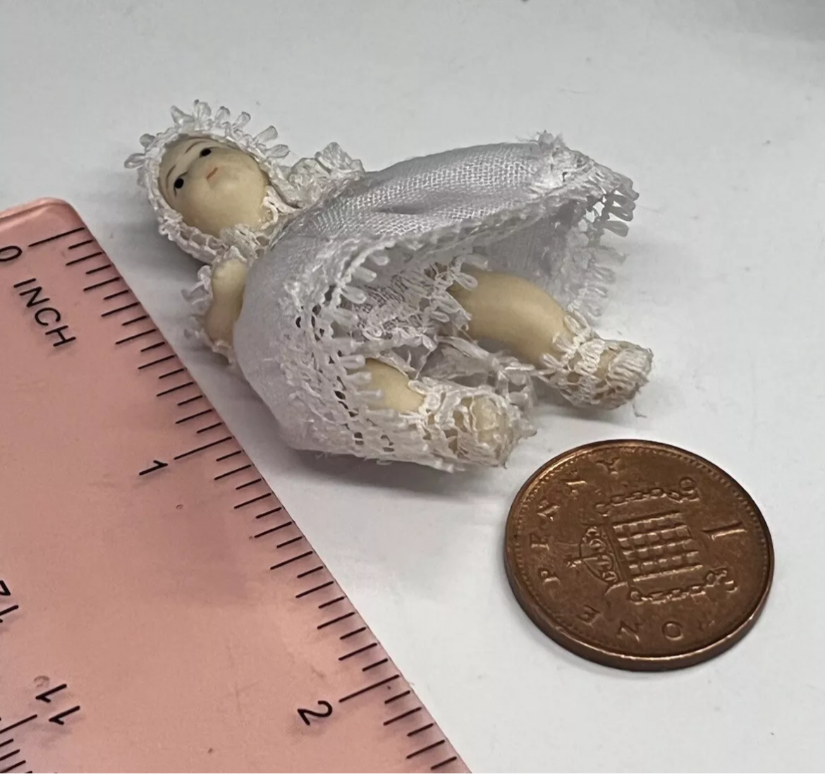 Dolls house metal white wire pram and baby.