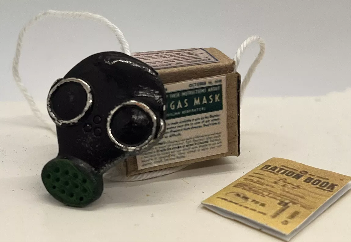 Dolls house has mask, ration book and gas mask box. (New)