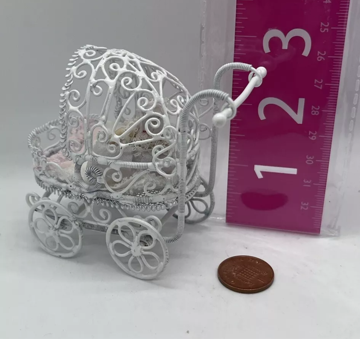 Dolls house metal white wire pram and baby.