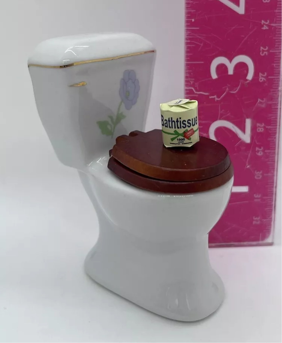 Dolls house toilet and toilet roll.