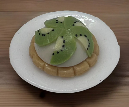 Dolls house kiwi tart on a plate
