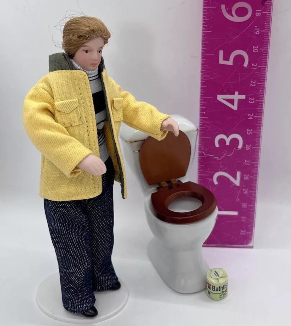 Dolls house toilet and toilet roll.