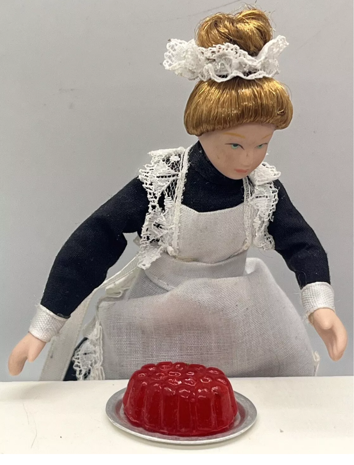 Dolls house strawberry jelly on a metal plate