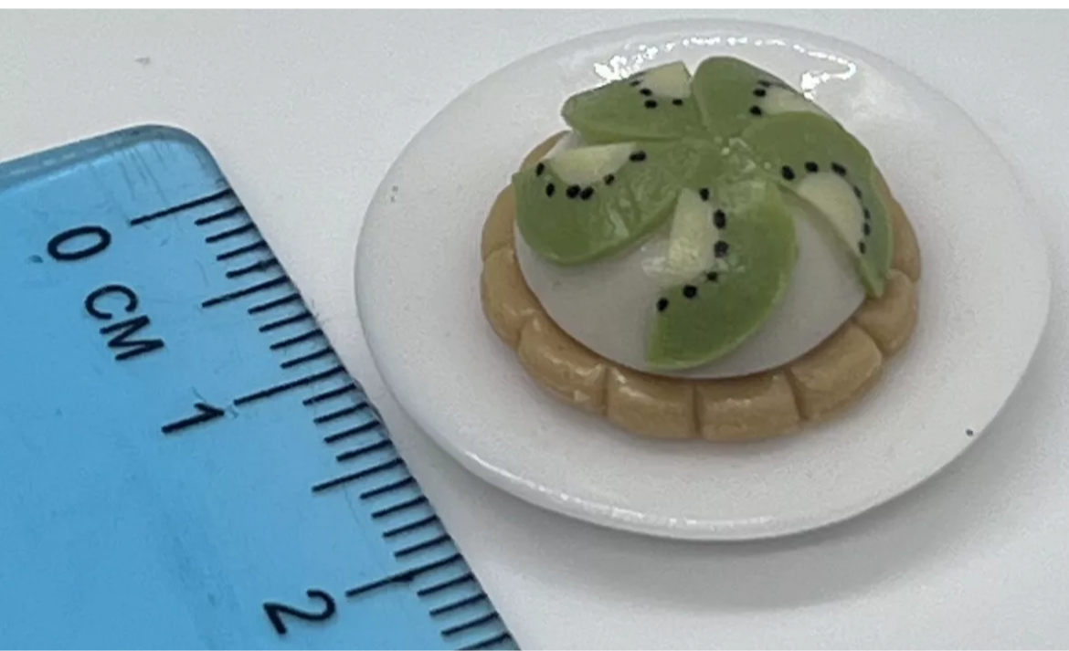 Dolls house kiwi tart on a plate