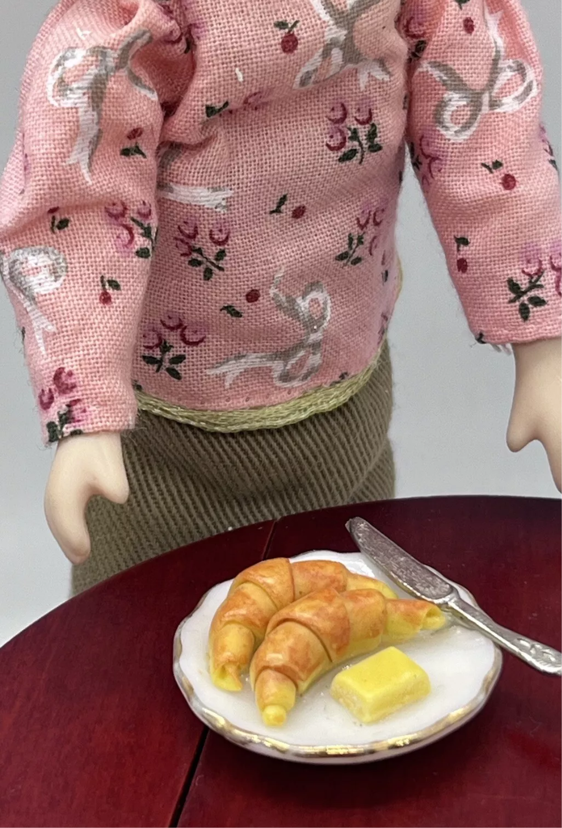 Dolls house croissant, butter & knife on plate