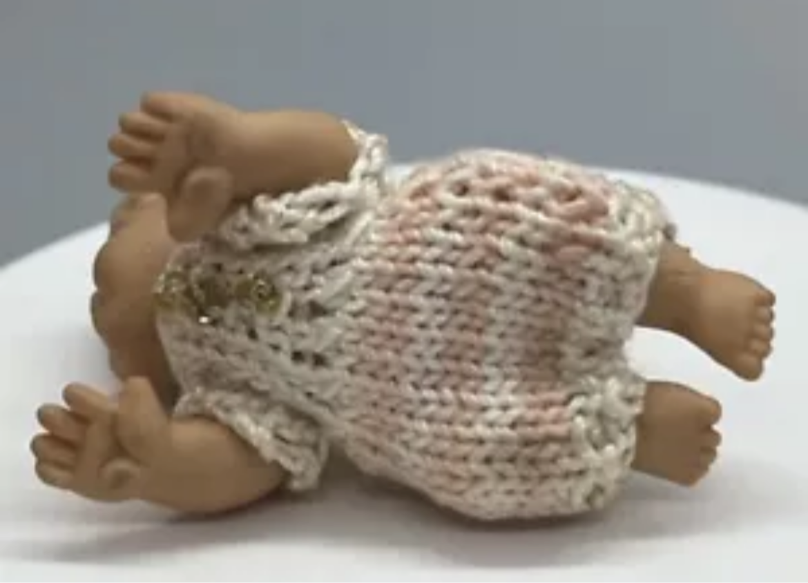 Dolls house baby with hand knitted romper