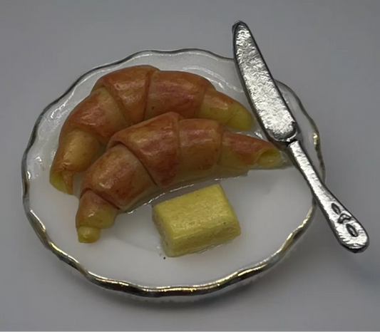 Dolls house croissant, butter & knife on plate