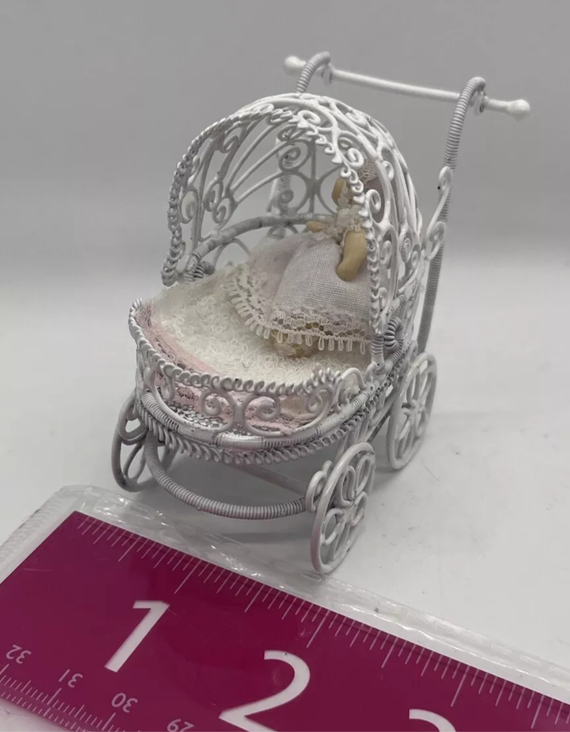 Dolls house metal white wire pram and baby.