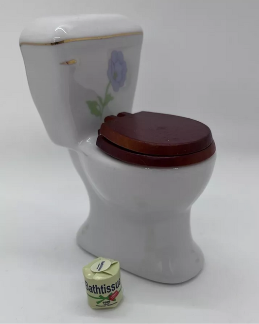 Dolls house toilet and toilet roll.