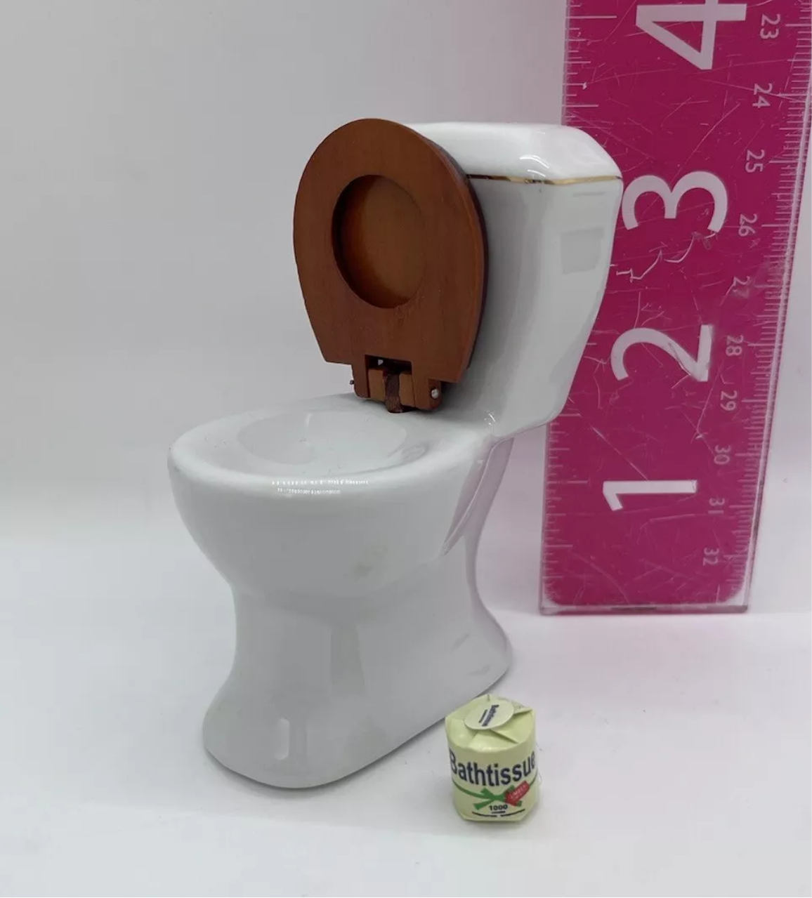 Dolls house toilet and toilet roll.