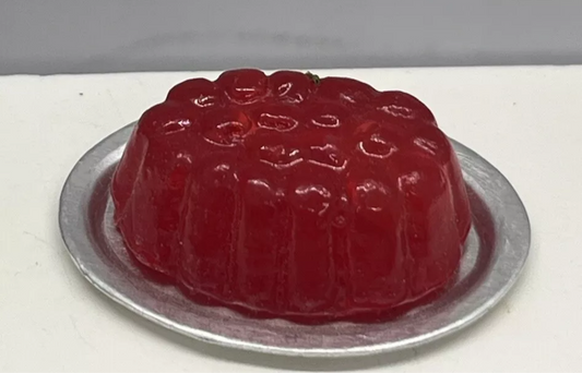 Dolls house strawberry jelly on a metal plate