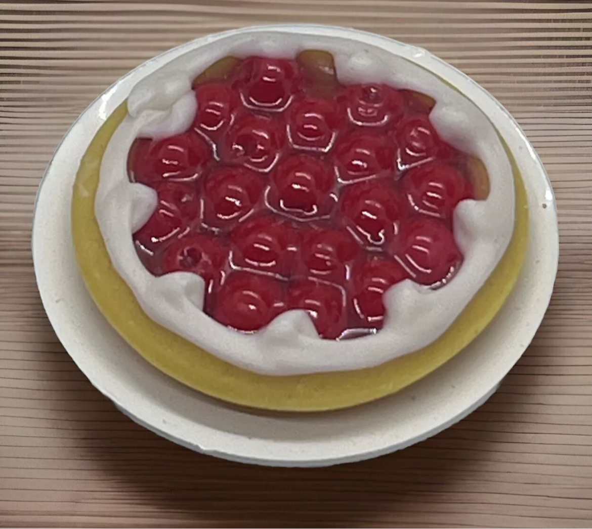 Dolls house cherry tart on a plate