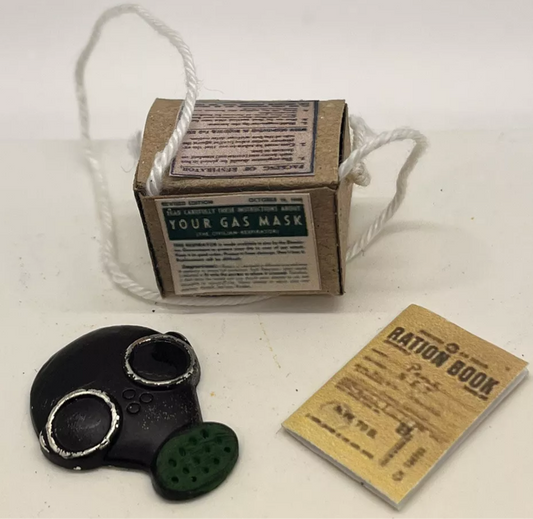 Dolls house has mask, ration book and gas mask box. (New)