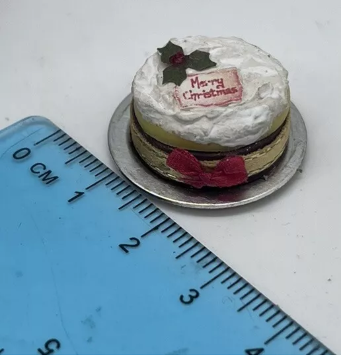 Dolls house Christmas cake on metal plate