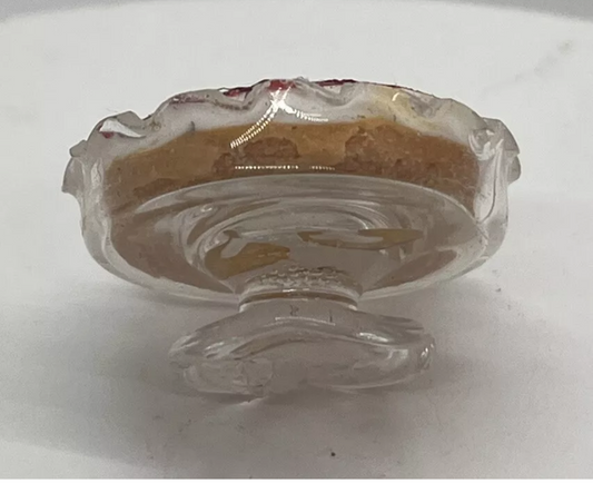 Dolls house strawberry cheesecake on glass pedestal